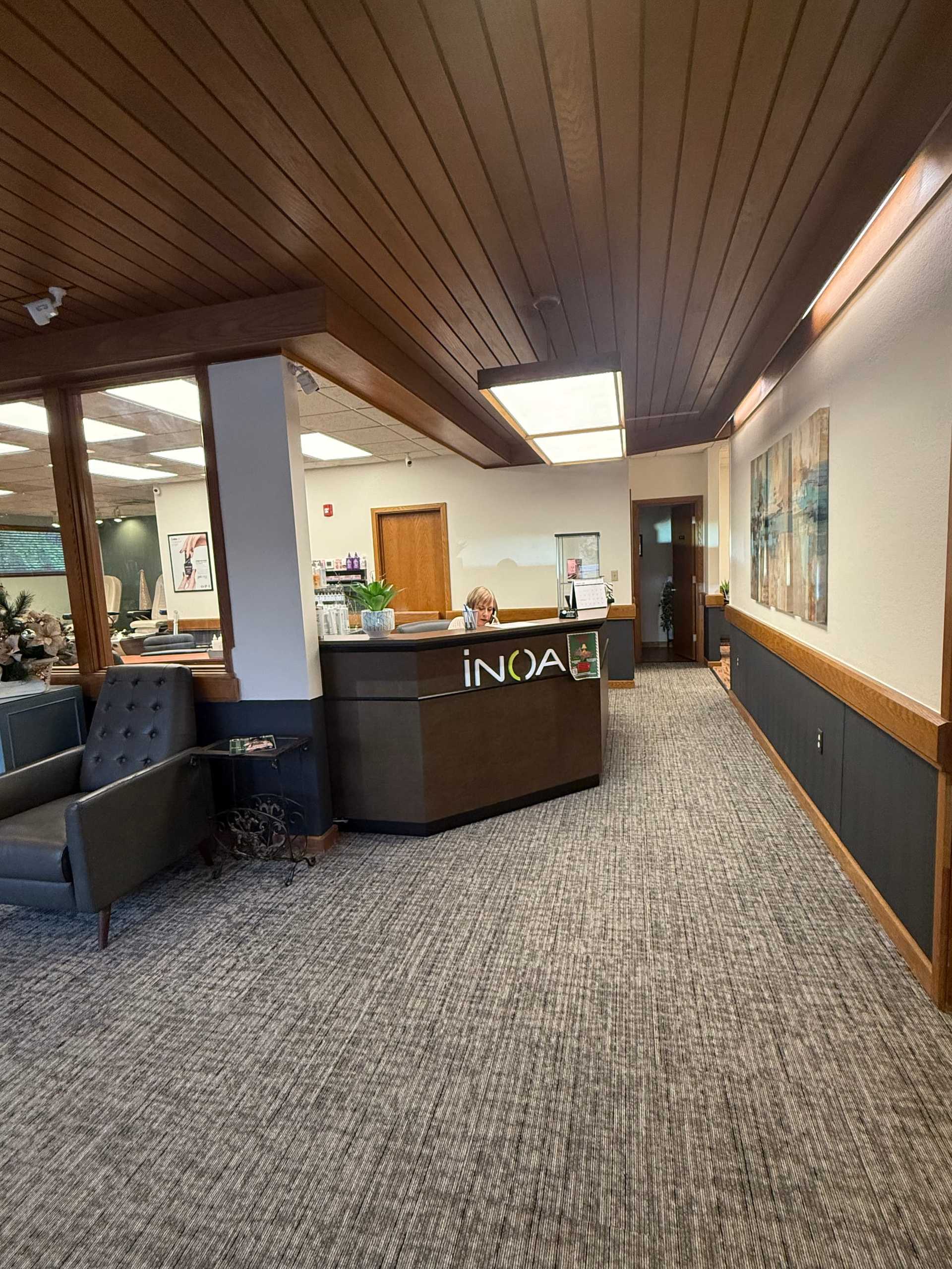 Reception area of an office with a modern desk and comfortable seating.